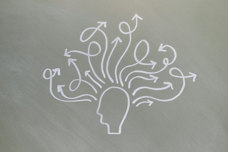 Conceptual chalk drawing illustrating mental health challenges with arrows representing thoughts.